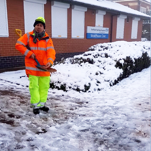 Council worker clearing snow outside Woodhouse Clinic