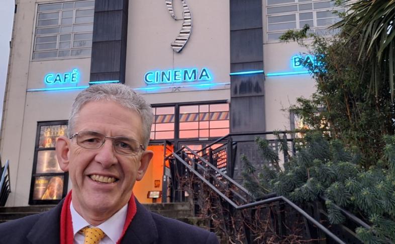 Cllr Martin Smith standing at the bottom of steps outside the Showroom Cinema.