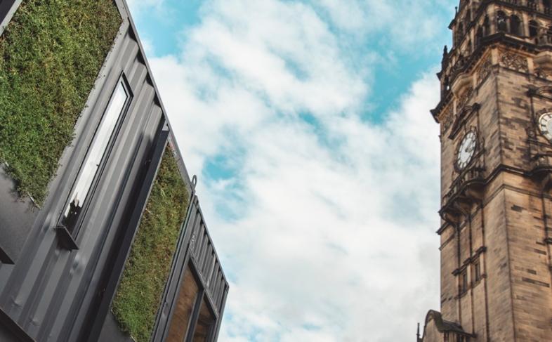 Image of the grey Fargate containers with the Town Hall clock in the background