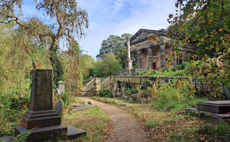 Image of the Sheffield General Cemetery with trees and gravestones in the foreground