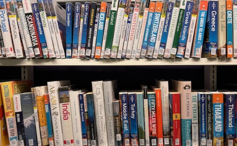 Library books along 2 shelves under the category Countries and People