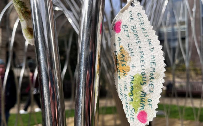 A leaf made of fabric with a memorial written on it 