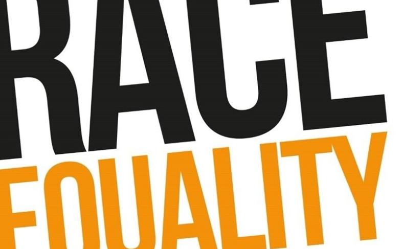 Race Equality Commission logo in orange and black letters on a white background