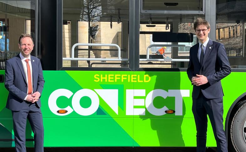 Cllr Ben Miskell and Cllr Tom Hunt standing in front of a green Sheffield Connect fully electric bus