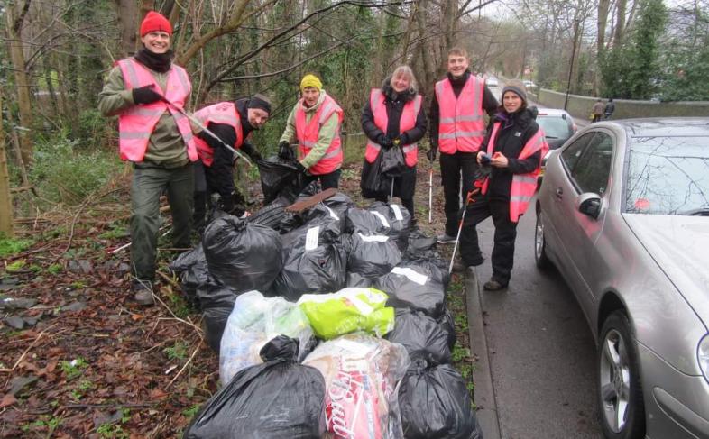 Sheffield Litter Pickers at a previous event on the side of a road pictured with a number of bags of litter