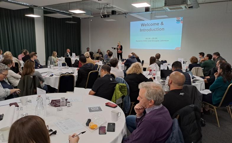 The room of attendees at the Rough Sleepign Summit listen to a speaker