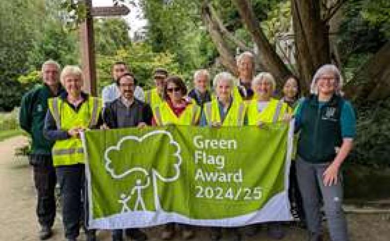 Cllr Kurtis Crossland with volunteers and memebrs of the Sheffield General Cemetery Trust holding an official Green Flag