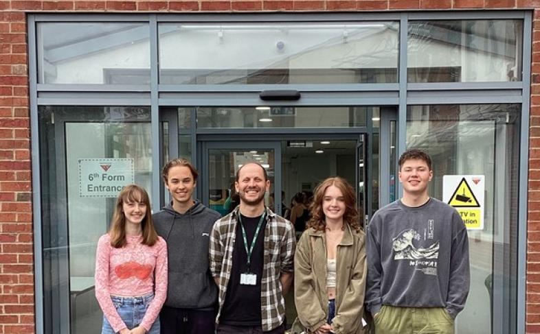 Group of A level students and their teacher standing outside Meadowhead School Sixth Form Centre