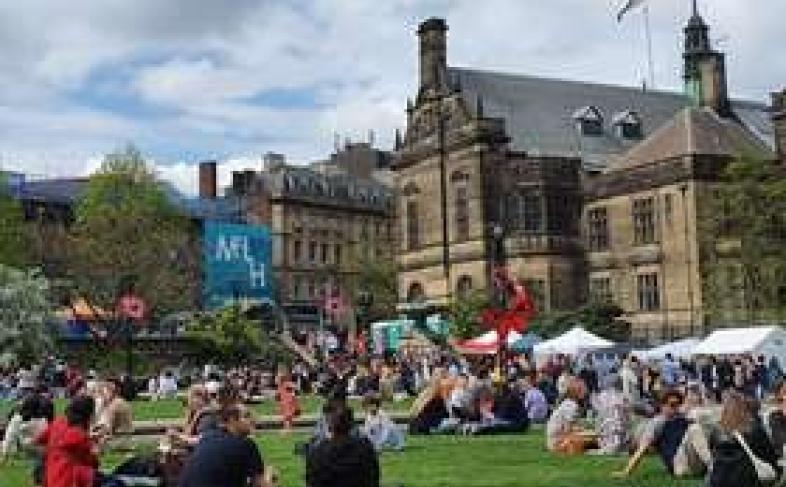 A packed Sheffield Peace Gardens enjoys a busy event in front of the Town Hall on a cloudy day