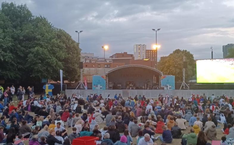 A crowd of people watching a stage on Devonshire Green