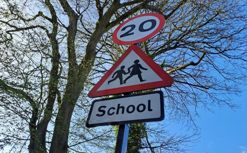 A 20mph road sign warning of a school nearby.