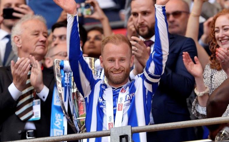 Barry Bannan on the balcony at Wembley Stadium applauding the Sheffield Wednesday fans, he has a victory medal around his neck