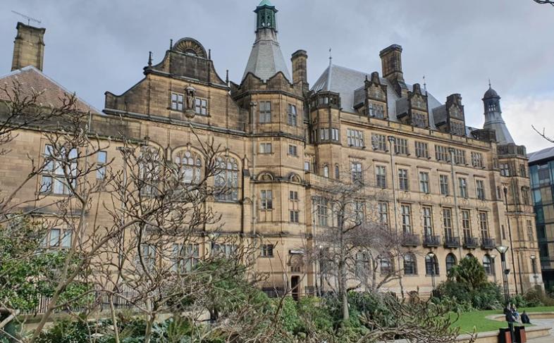 The side of Sheffield Town Hall can be seen with the Peace Gardens in the foreground surrounded by trees