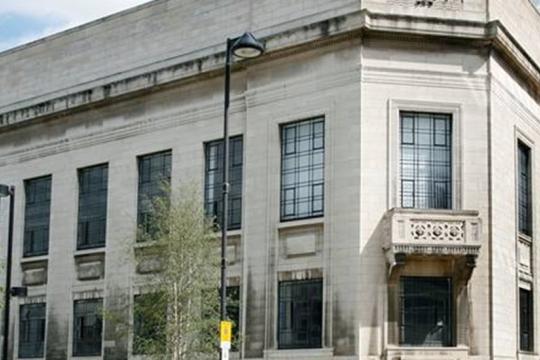 Image of the Central library in Tudor Square. A cream building with lots of windows