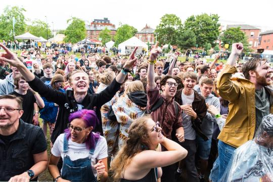 A crowd of people enjoying an event at Devonshire Green