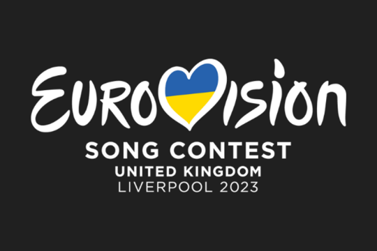 The main logo for Eurovision with a flag for Ukraine entered into the V which has been transformed into a heart.