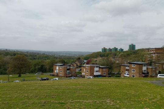 A view looking down on homes in Gleadless Valley, with grass stretched in front of them