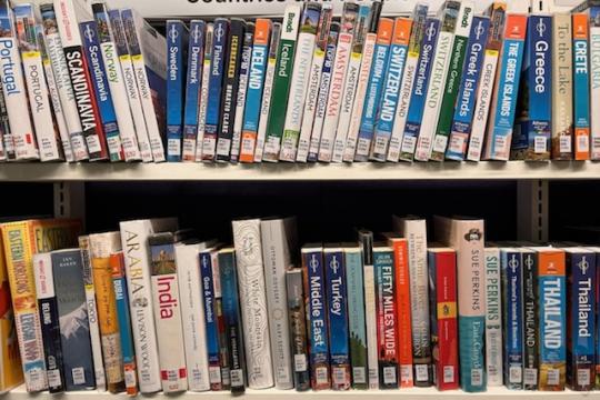 Library books along 2 shelves under the category Countries and People