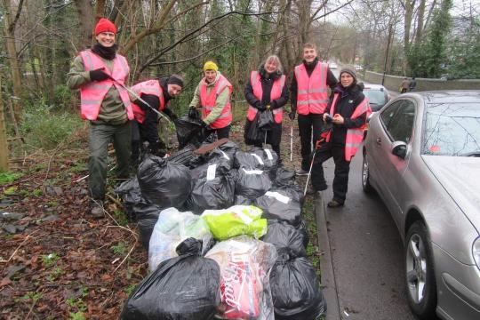 Sheffield Litter Pickers at a previous event on the side of a road pictured with a number of bags of litter