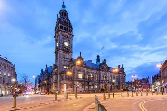 Sheffield Town Hall at dusk illuminated by street lights