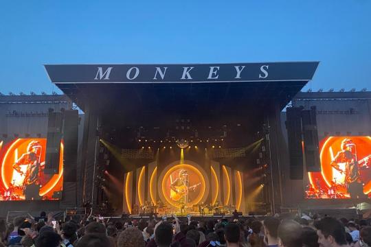 The Arctic Monkeys performing on stage.