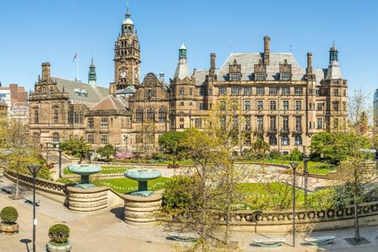 Sheffield Peace Gardens on a sunny day with the Town Hall in the background. 