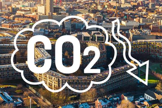 Bird's eye view of Sheffield with the word CO2 overlayed and an arrow pointing down