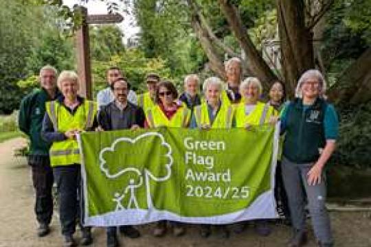 Cllr Kurtis Crossland with volunteers and members of the Sheffield General Cemetery Trust holding an official Green Flag