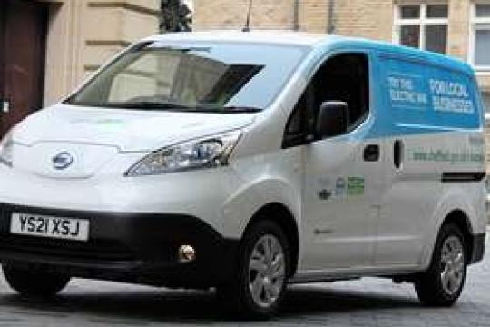 An electric van parked up on a quiet street