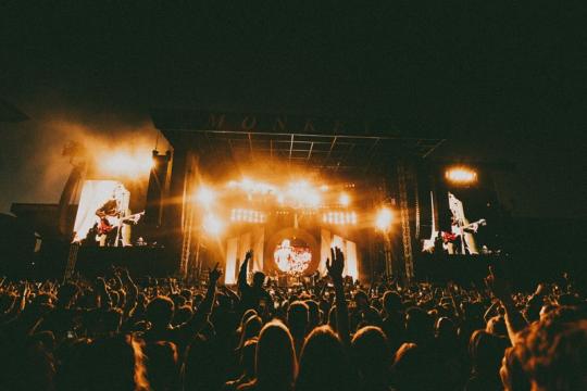 Arctic Monkeys live on stage - photo credit Lewis Evans