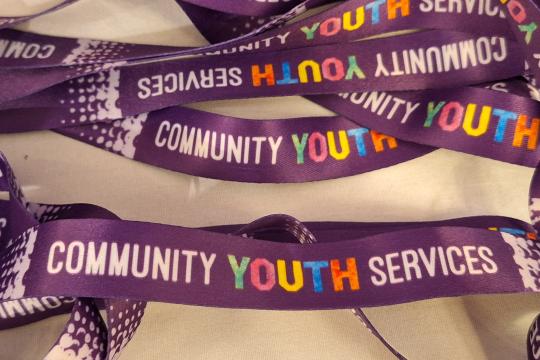 Community Youth Services logos on a purple lanyard