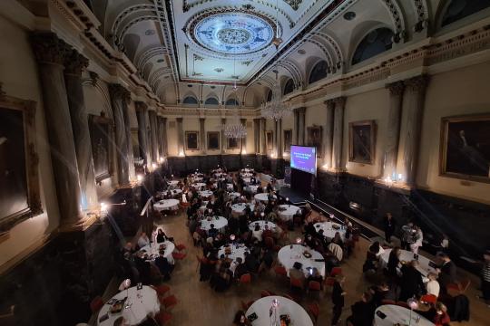 View from above of a room in a grand hall with tables and chairs set up 