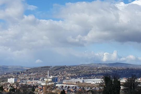 The Sheffield skyline with blue sky and white fluffy clouds hovering over Sheffield city centre