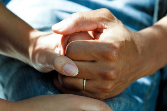 Two people holding hands 